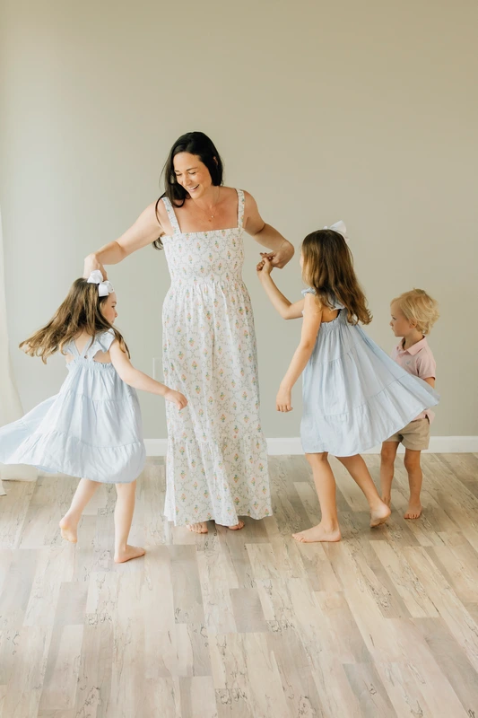 Candid Photo of Mother and Kids Dancing